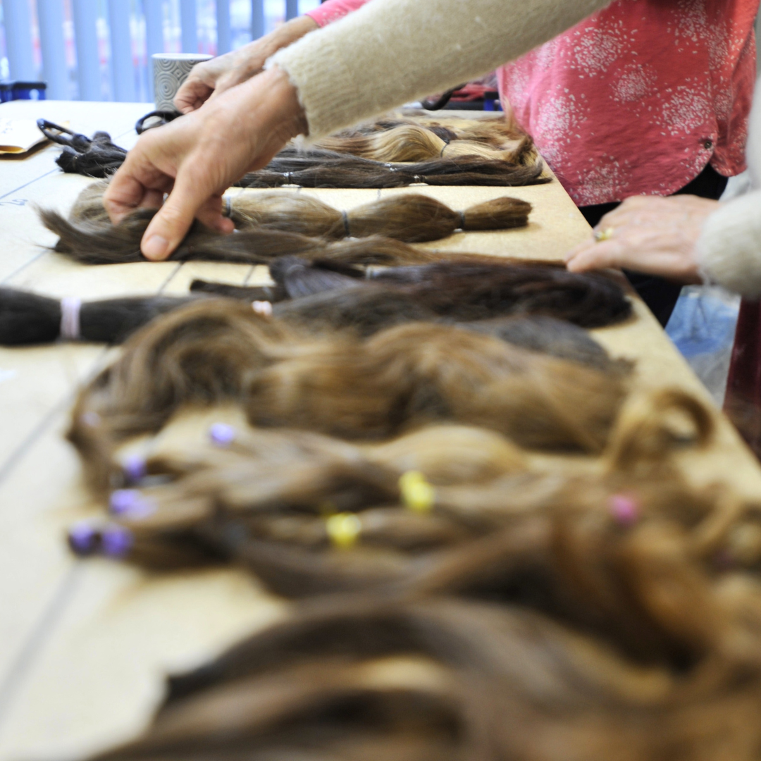 Volunteers sorting donated hair
