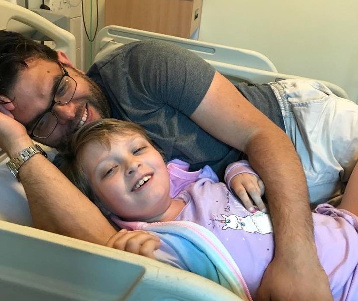 Adam in hospital with Hannah when the cancer sadly returned.