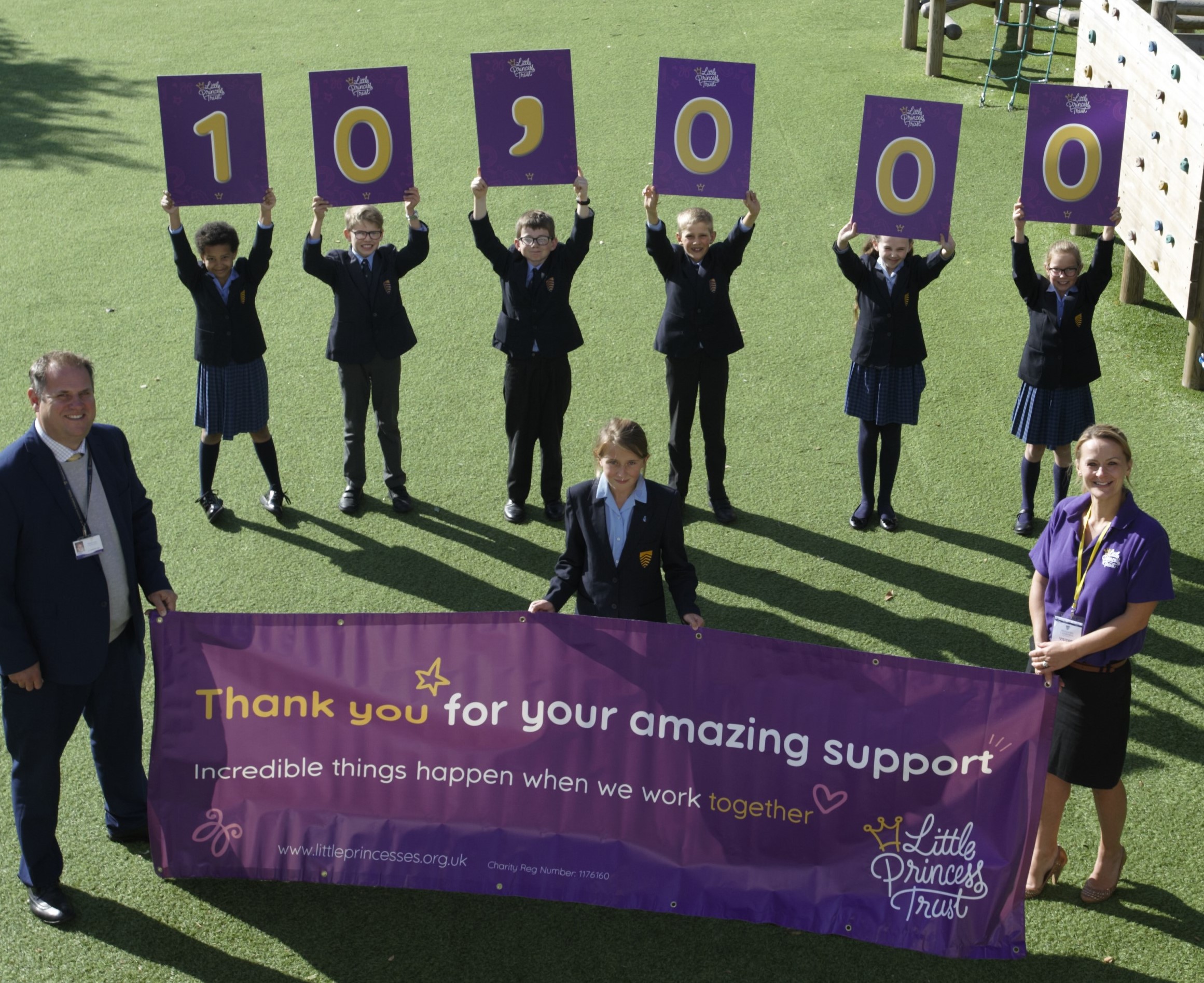 Wendy Tarplee-Morris, Founder of The Little Princess Trust, with James Debenham, Deputy Head of Hereford Cathedral Junior School, mark the milestone with pupils from the school. The Little Princess Trust was started in memory of Hannah Tarplee, who was a pupil at Hereford Cathedral Junior School.