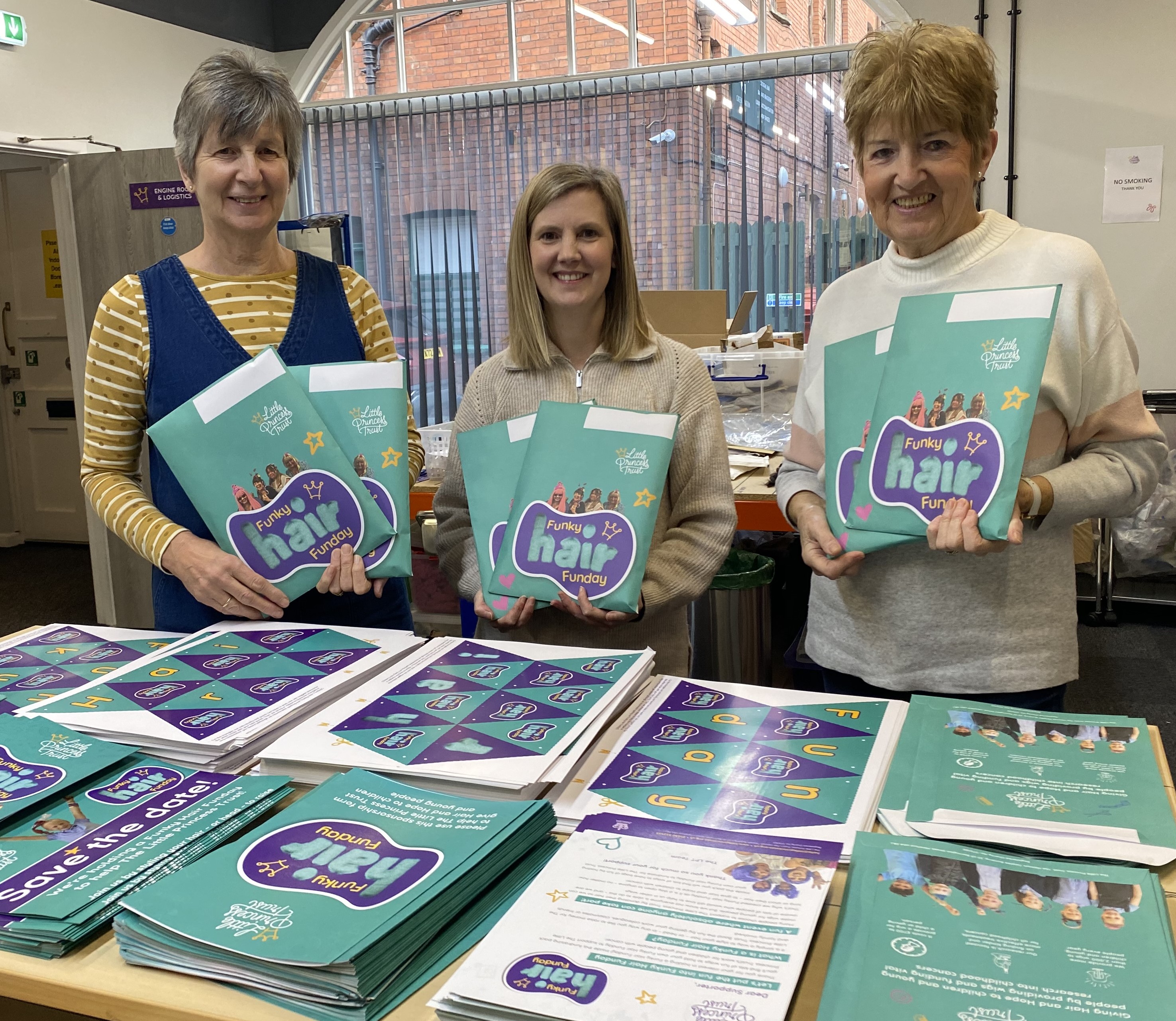 Little Princess Trust volunteers Jayne Broome (left) and Di Butler (right) have been busy with LPT Logistics Assistant Donna Clarke making up the new Funky Hair Funday fundraising packs.