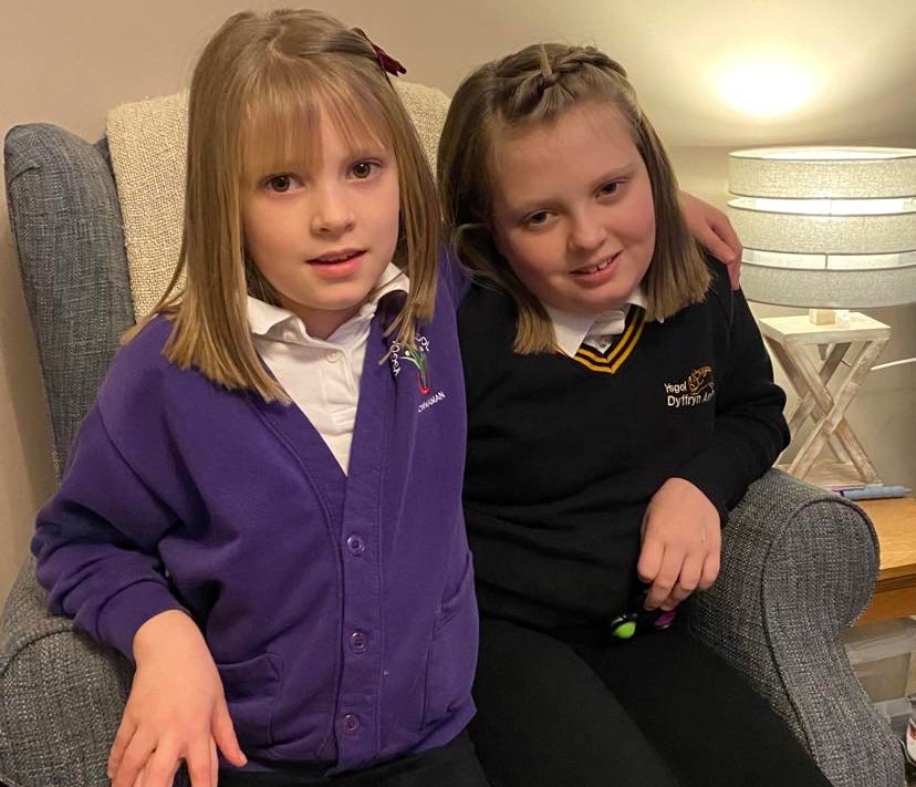 Hannah and her sister Lucy (left) shortly after they both donated their hair to us.