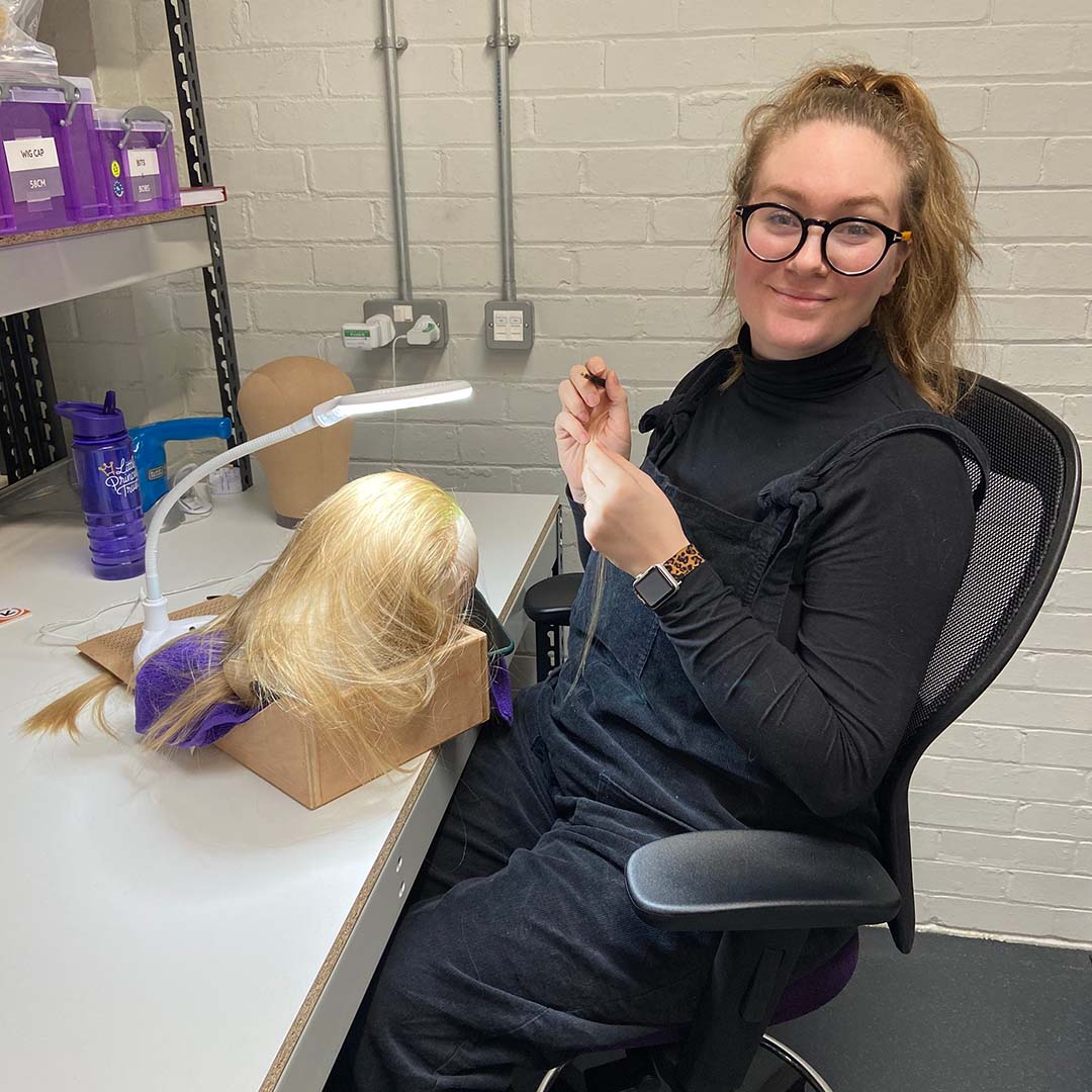 This is Holly knotting a wig at The Little Princess Trust