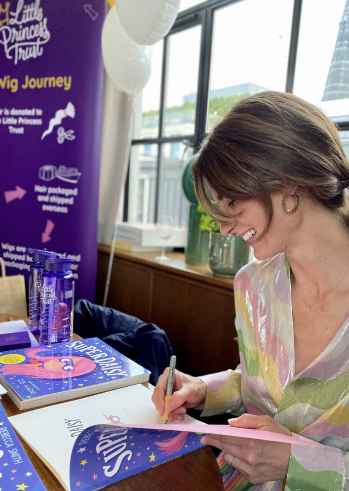 Rebecca Smith signs copies of SuperDaisy at the book launch in London.