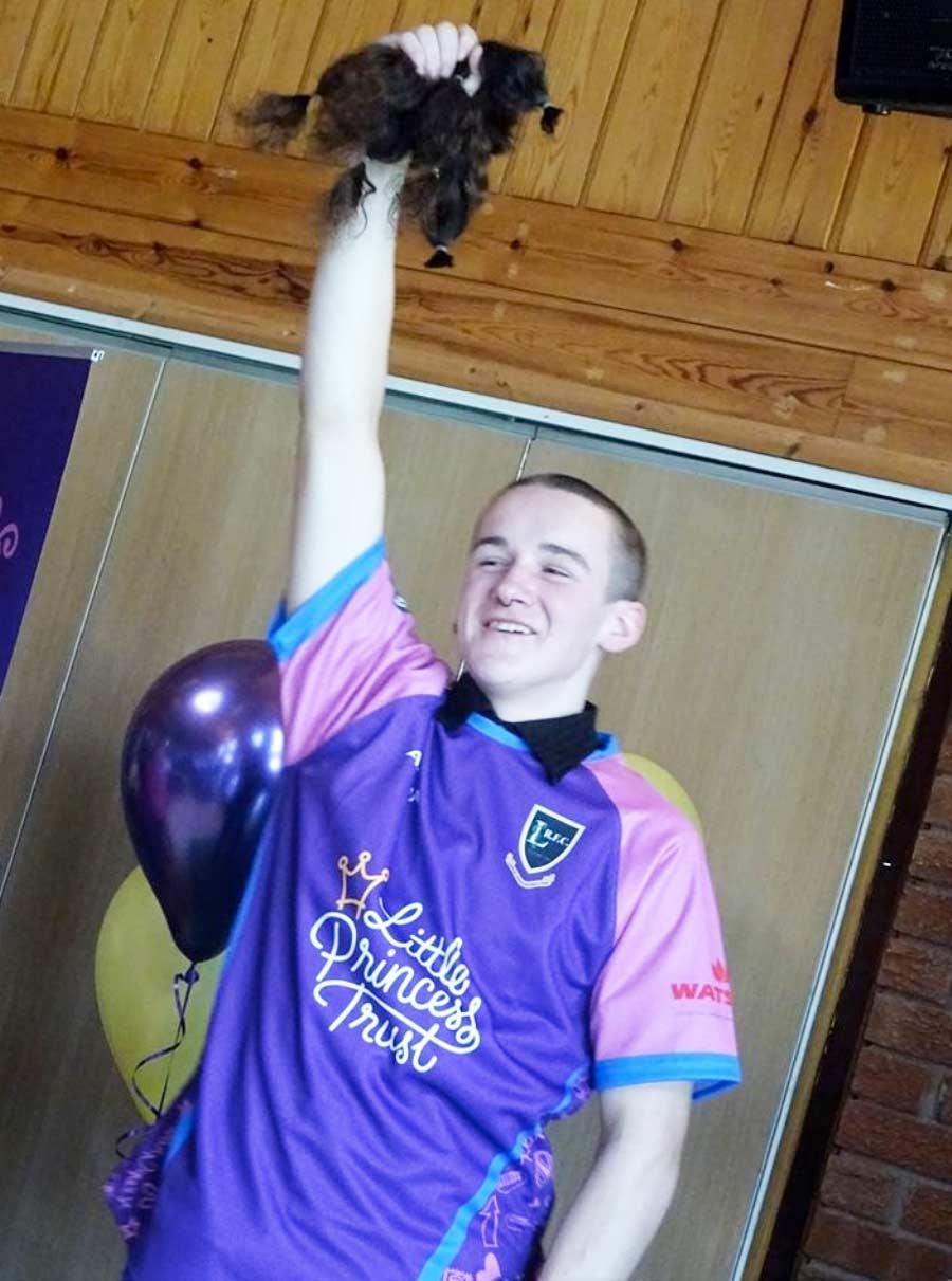 Jay Smith holds up his hair after his first cut in 10 years