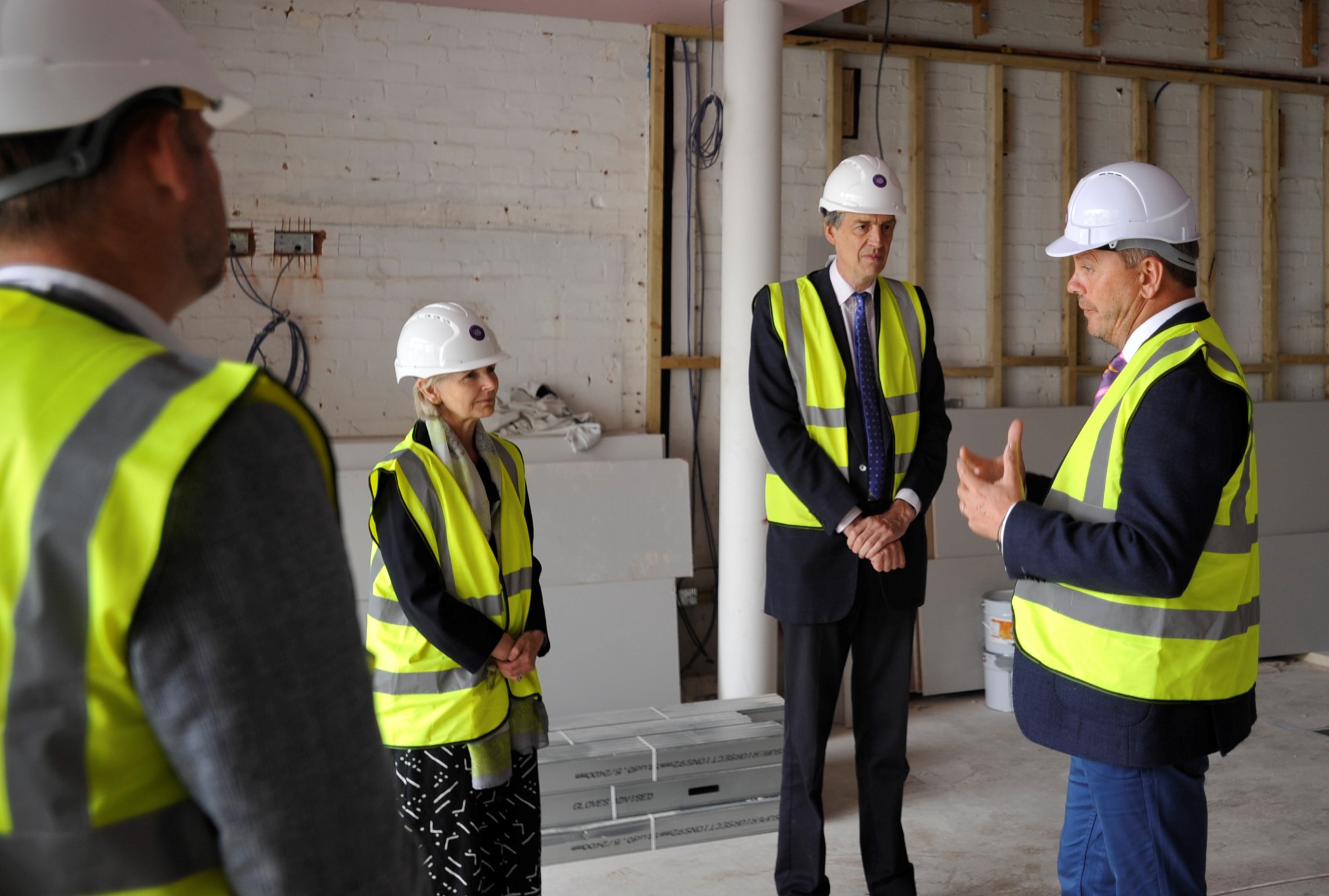Phil Brace, Chief Executive of The Little Princess Trust, gives the Lord-Lieutenant to Herefordshire, Edward Harley, and his wife Victoria a tour of The Hannah Tarplee building as work progresses on the charity's new headquarters.