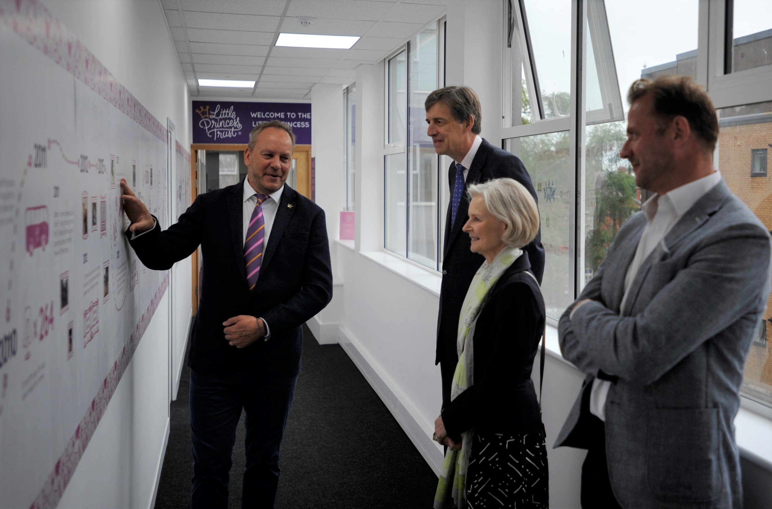 Phil Brace, Chief Executive of The Little Princess Trust, explains the history of the charity to the Lord-Lieutenant to Herefordshire, Edward Harley, his wife Victoria and Deputy Lieutenant William Lindesay. 