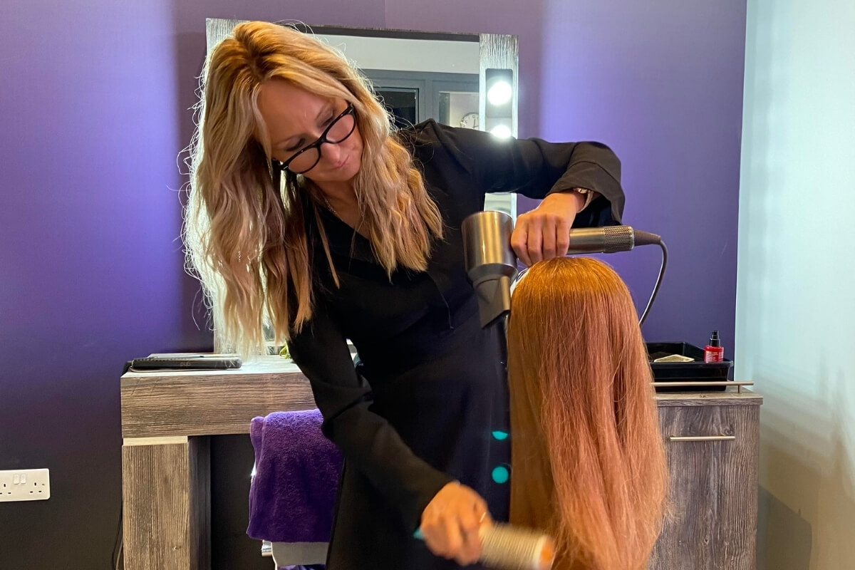 Liz Pullar our Mobile Wig Fitter, styling a wig in the new Sally's Salon