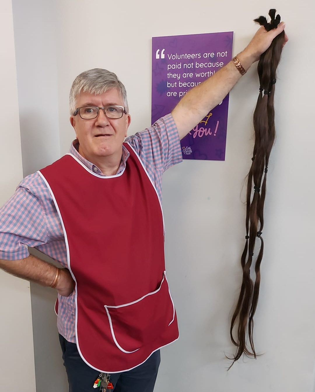 LPT's Graham Vaughton-Morris holds the record-breaking hair donation aloft.