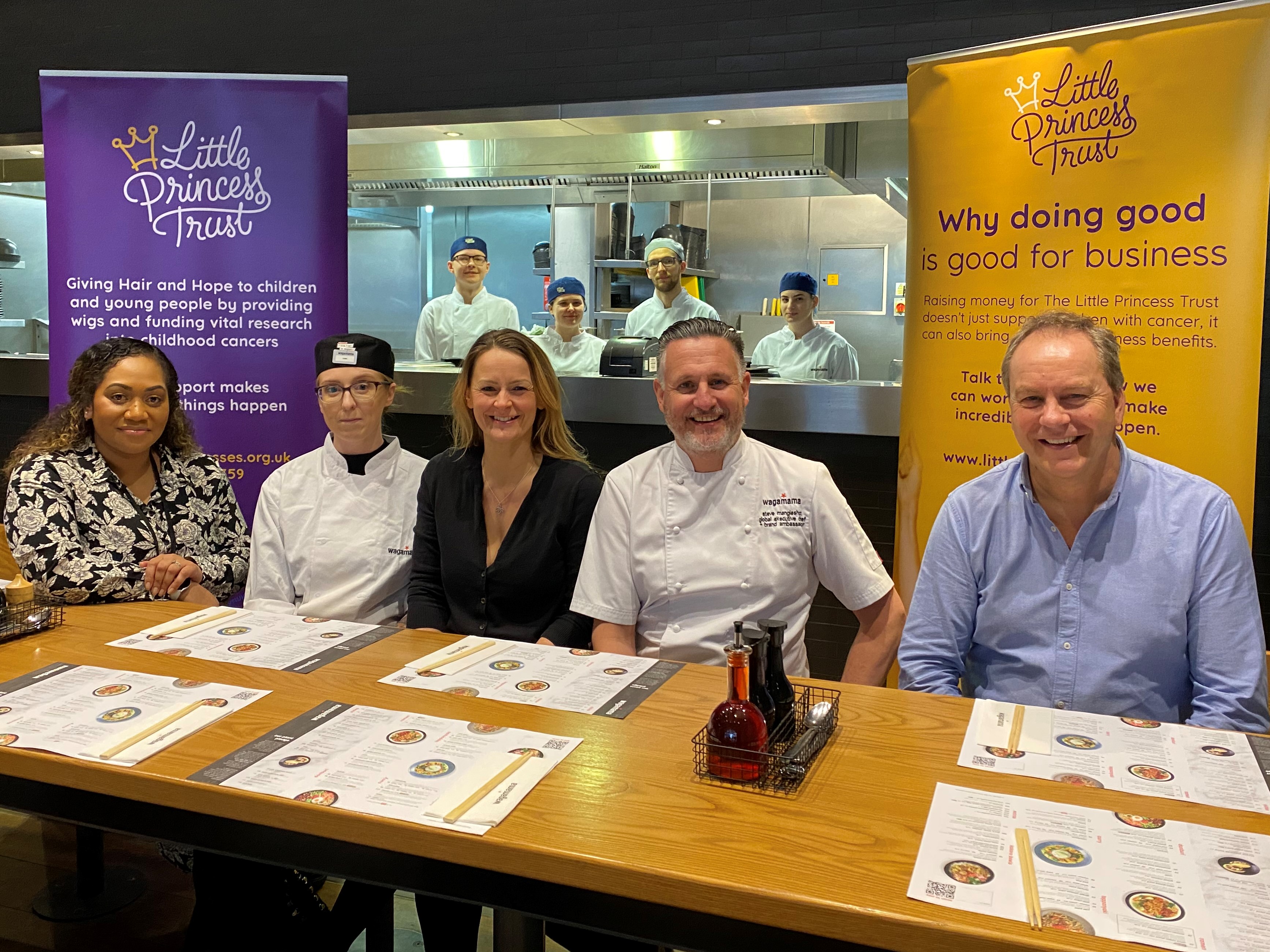 Seated at Wagamama in Hereford are Phil Brace (right) and Wendy Tarplee-Morris (centre), from The Little Princess Trust, with Emi-Luisane Richards-Buadromo (left), Steve Mangleshot and Head Chef Keri Blackwell. And in the kitchen are (l-r) Jakub Madejski, Hannah Sheehan, Mateusz Baliga and Vanessza Jobbagy.