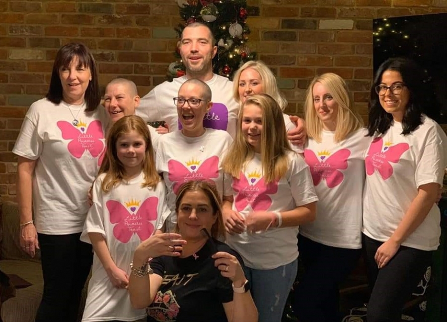 Hairdresser Kerry Adlem is pictured with Jodi and her friends and family - many of whom also had their hair cut to donate it to The Little Princess Trust before Jodi began her treatment. 
