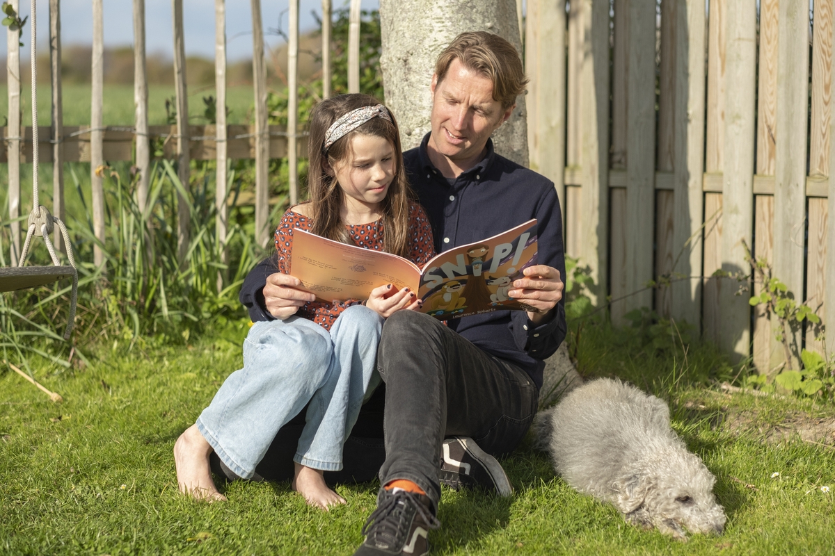 Lawrence Roberts reads Snip! with his 9-year-old daughter, Mia. Photo: Keiron O'Connor.