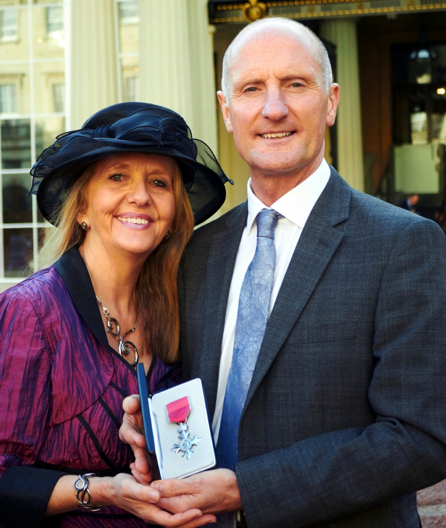 Tim Wheeler, The Little Princess Trust Chair of Trustees, and his wife Margaret outside Buckingham Palace in London.